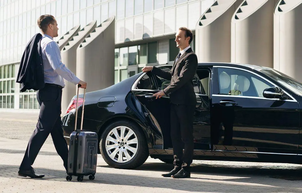 Business traveller boarding a corporate chauffeur car in Amsterdam
