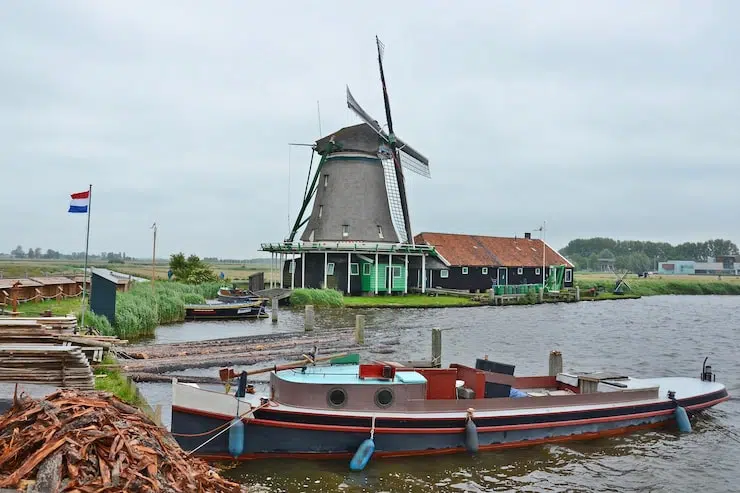 Traditional Dutch windmill beside water near Krommenie